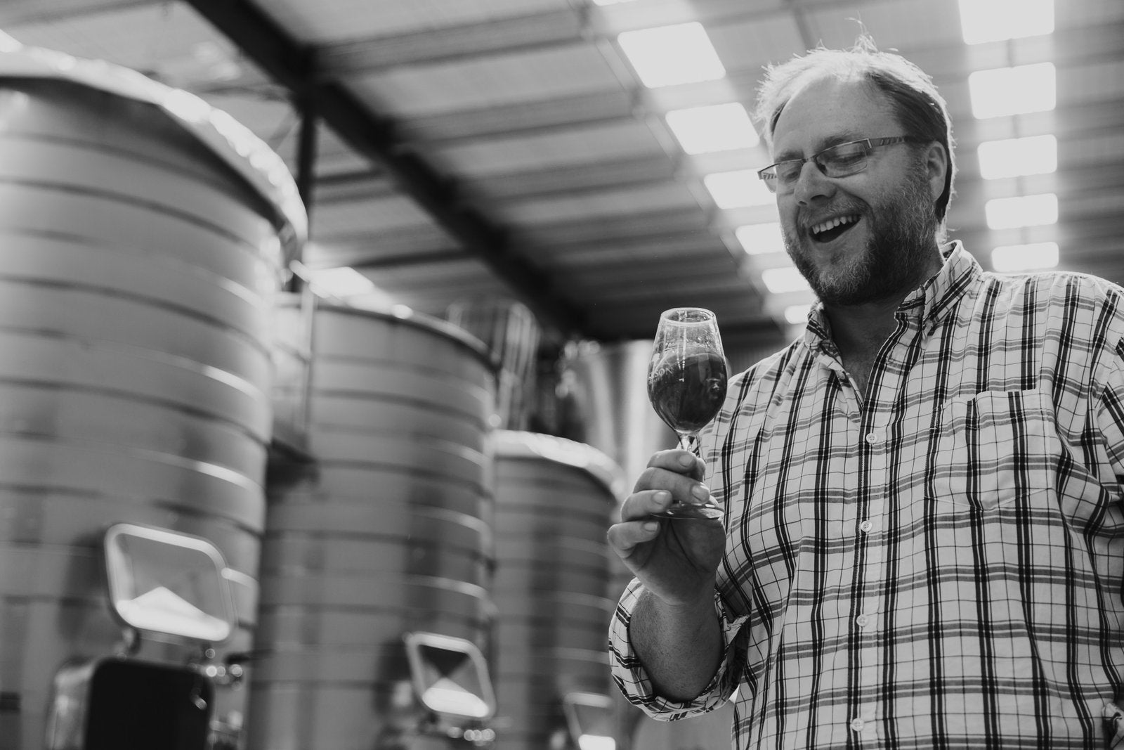 Drawing Pinot Noir from an oak barrel with a wine thief during vintage at Jackson Estate