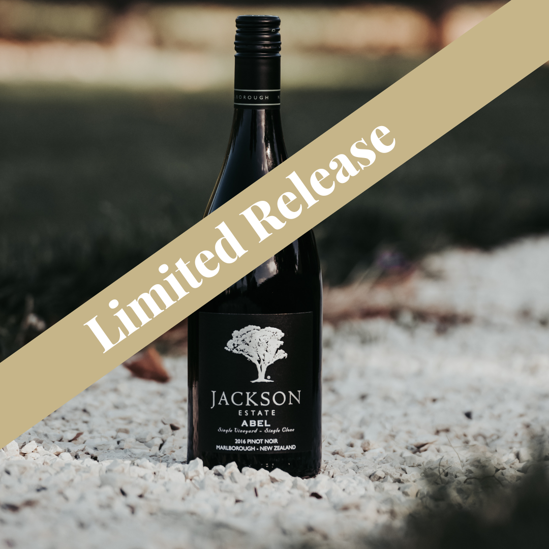 Jackson Estate Abel 2016 Pinot Noir limited release bottle resting on white gravel with soft natural light background