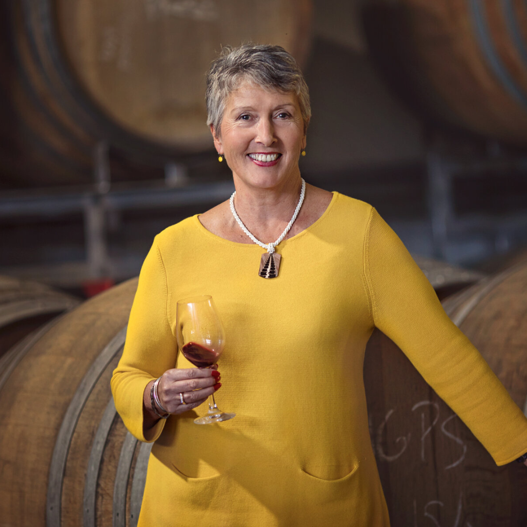 Woman holding a glass of red wine in a barrel room at Jackson Estate Winery