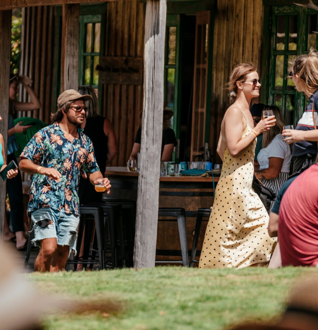 Guests enjoying drinks outdoors at Jackson Estate's cellar door on a sunny day